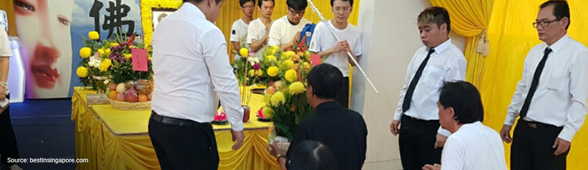 People holding a funeral service in Singapore